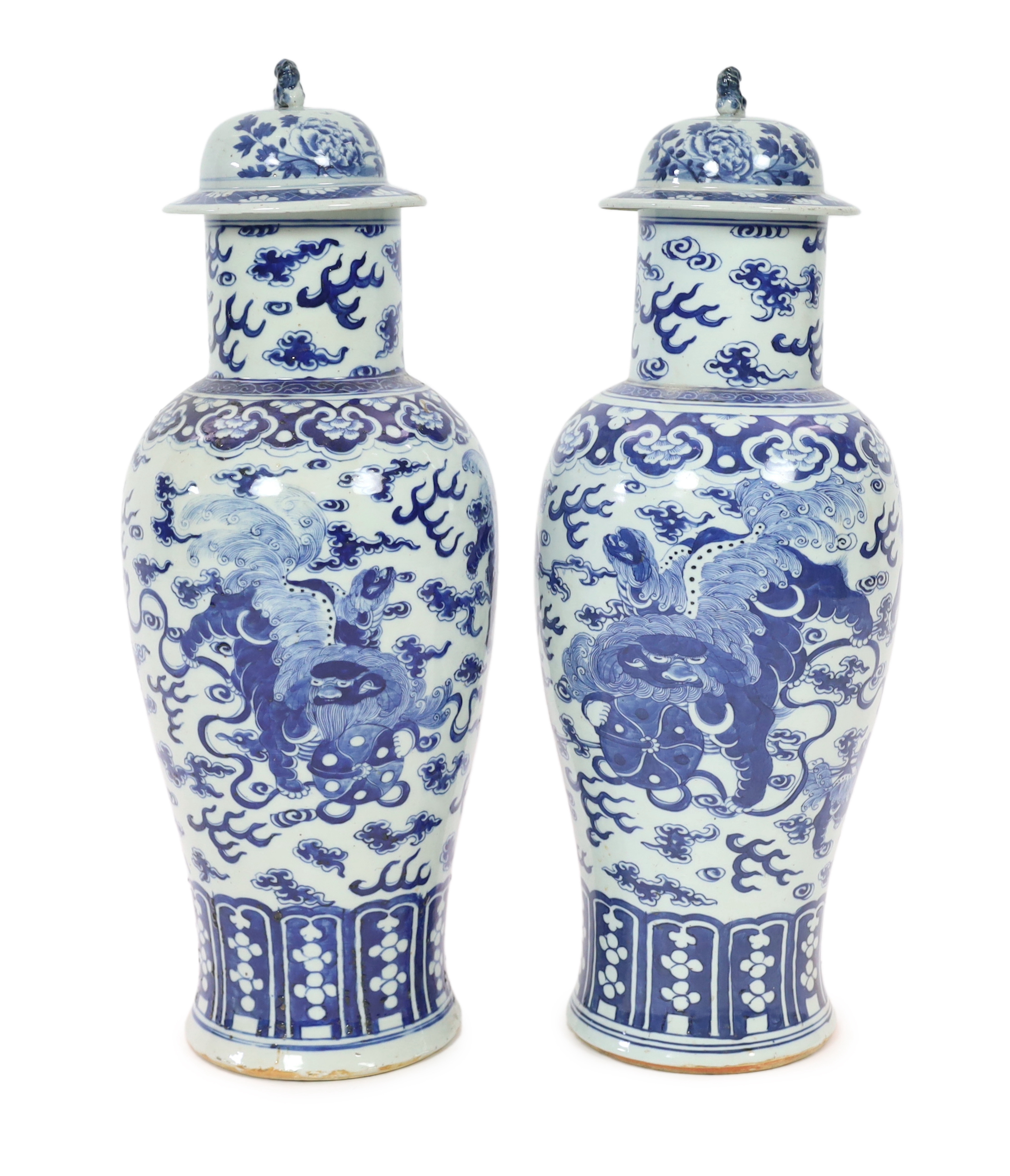 A pair of large Chinese blue and white ‘Buddhist lion’ vases and covers, 19th century, glaze imperfections